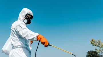 exterminator-in-protective-uniform-holding-toxic-s-2023-11-27-05-27-38-utc